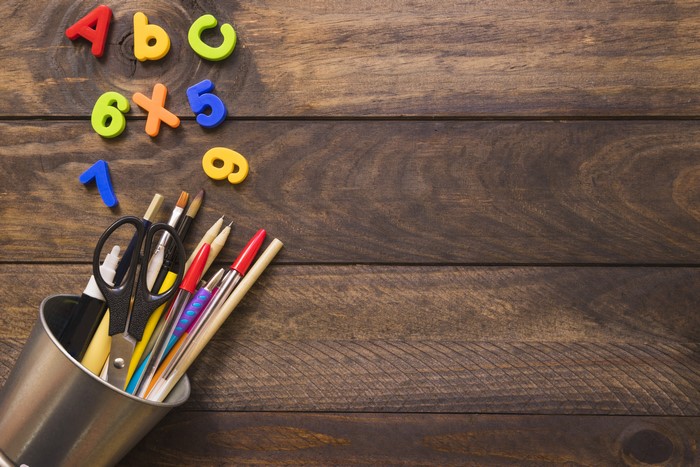 School supplies and letters on wood planks