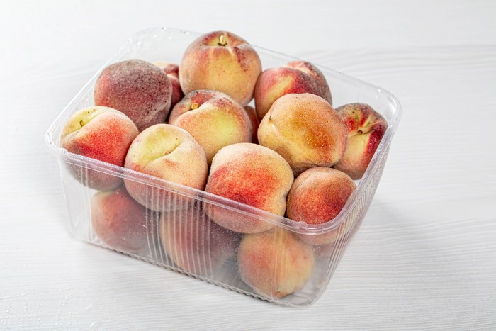 Peaches in a plastic container