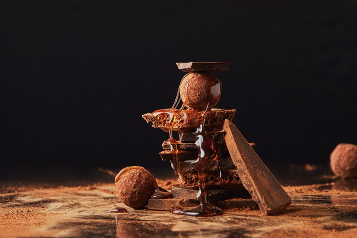 Chocolate truffles and broken chocolate bars with honey