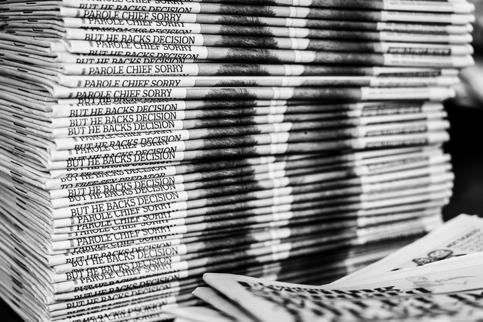 Stack of newspapers with headlines