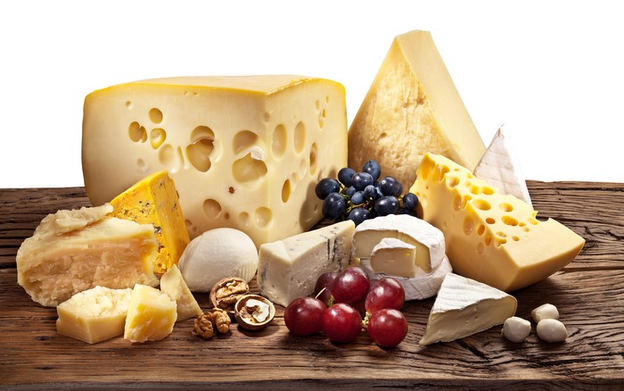 Assortment of Cheeses, Grapes, and Nuts on Wood Planks