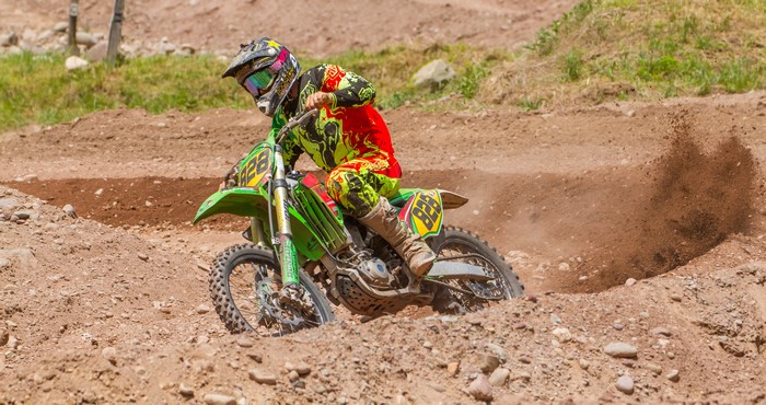 Motocross rider in action on a dirt track