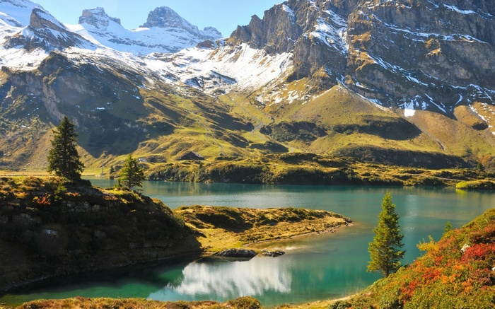 Turquoise lake and snow-capped mountains in autumn