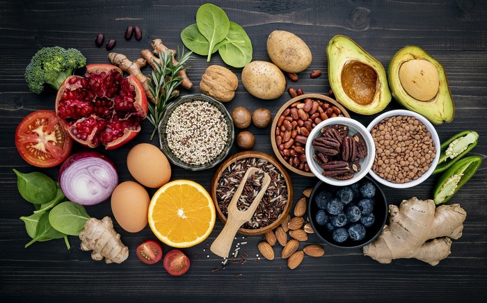 Assortment of Healthy Foods: Pomegranate, Avocado, Eggs, Nuts, and Grains
