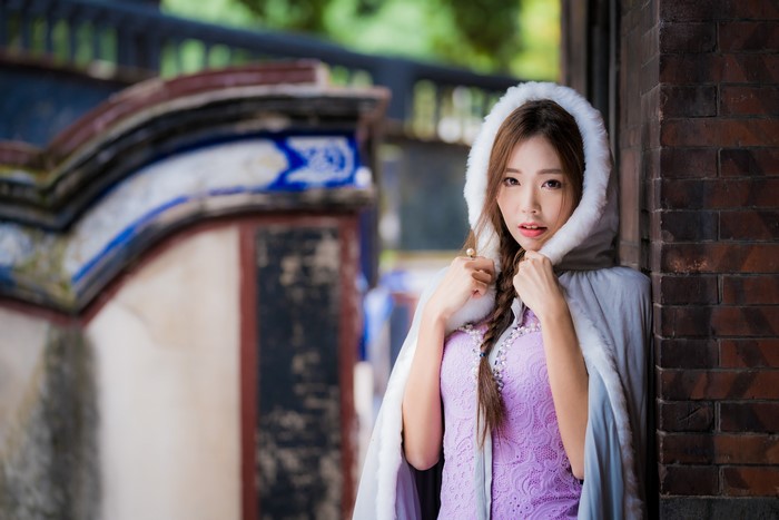 Asian woman with braid hair in purple dress