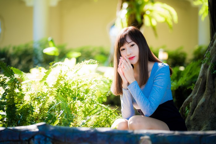 4K Portrait of Woman Sitting with Natural Bokeh