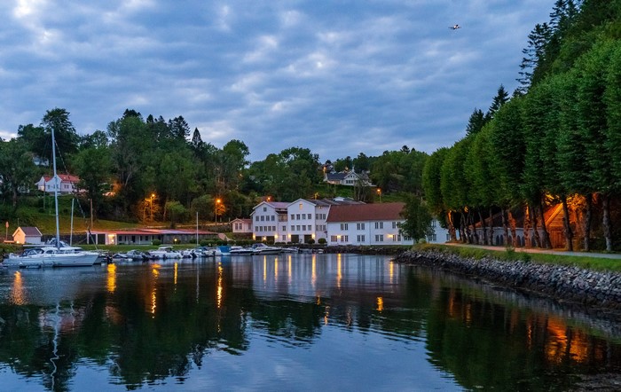 Marina and buildings by the water in Norway at dusk