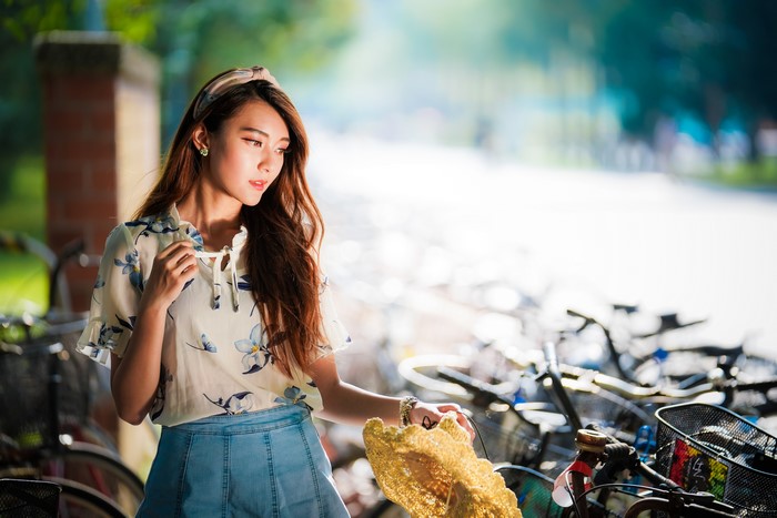 Asian woman with brown hair and floral shirt