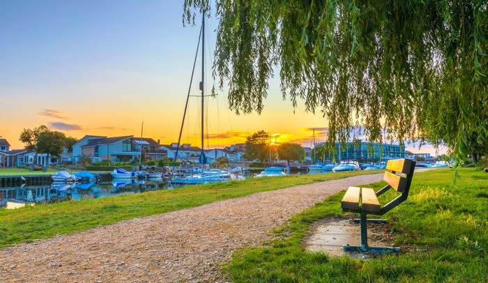 Sunset over river with boats and houses in Wick, England