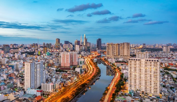 Ho Chi Minh City skyline with river and roads at dusk
