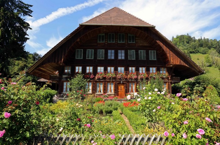 Wooden house with roses in Emmental, Switzerland