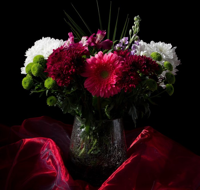 Bouquet of Flowers in a Vase on Red Fabric