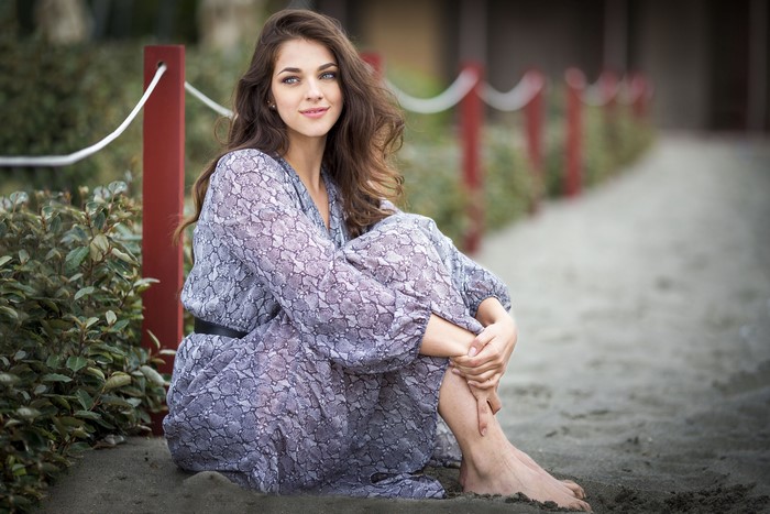 Elena sitting on the sand