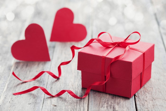 Red gift box with ribbon and hearts for Valentine's Day