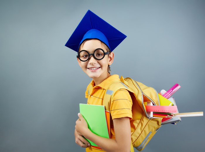 Boy with graduation cap and backpack