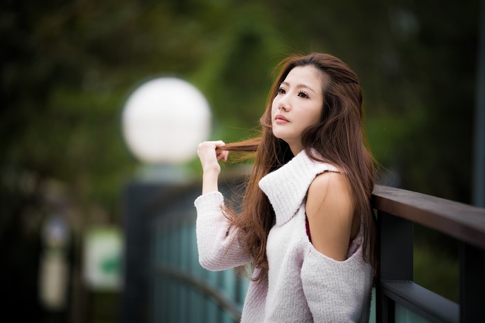 Asian woman with brown hair wearing a sweater