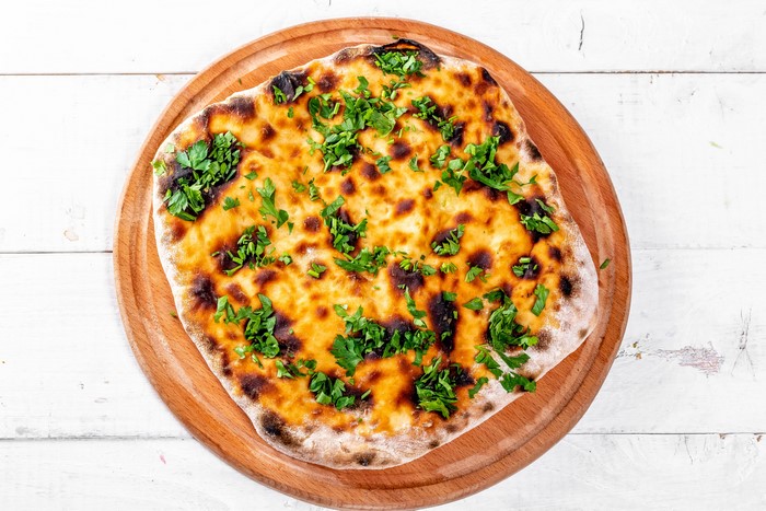 Khachapuri on a wooden cutting board