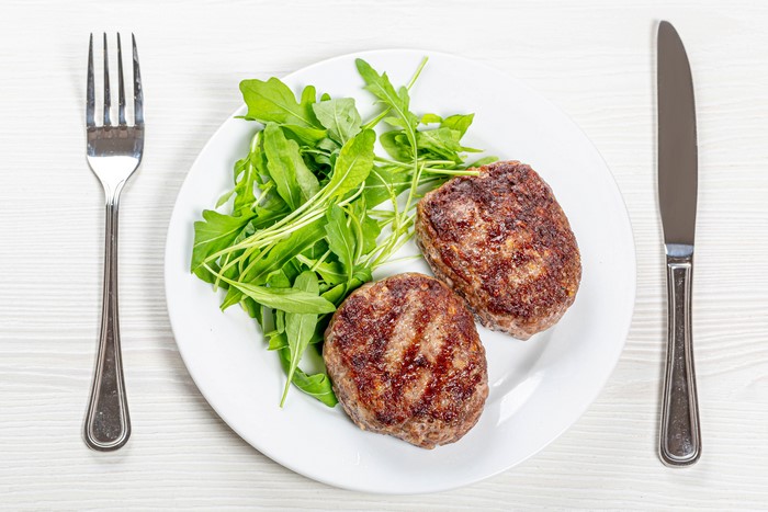 Two Frikadeller with Arugula Salad on a Plate