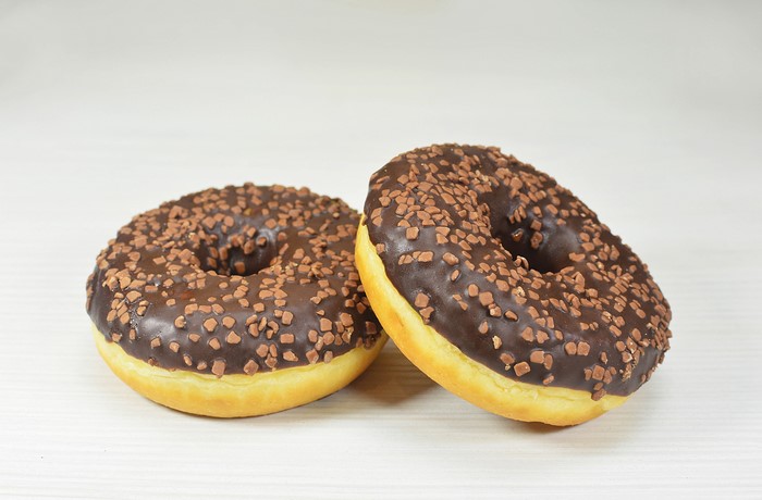 Two chocolate donuts with sprinkles