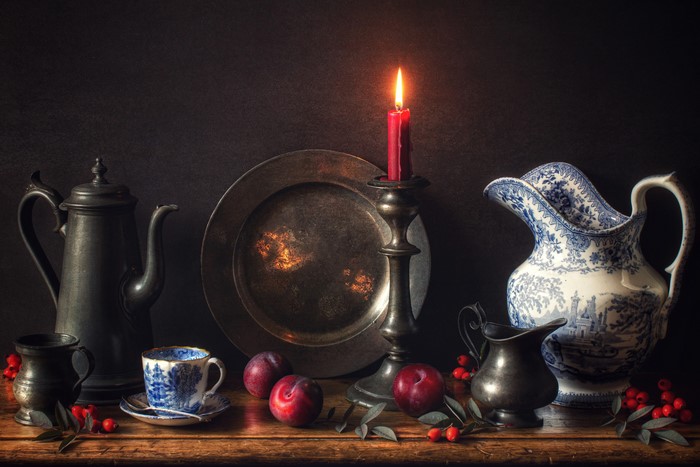 Still-life with candle, kettle, jug, cup, plate, plums, and rose hip