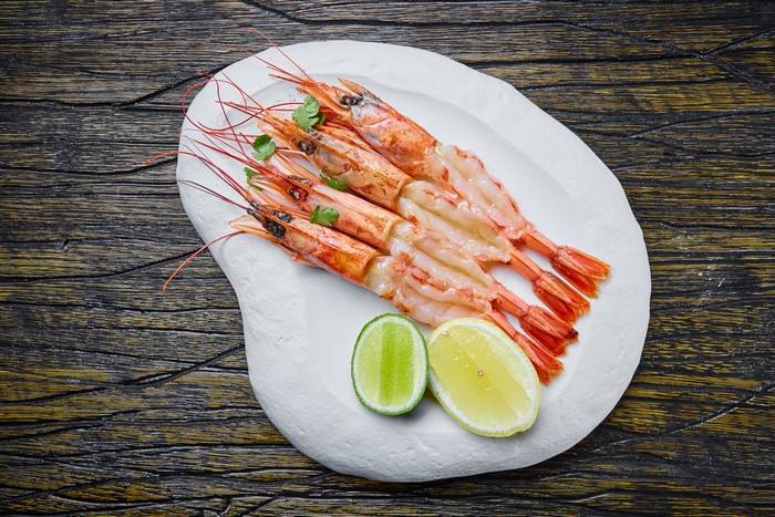 Cooked Shrimp with Lime on a White Plate