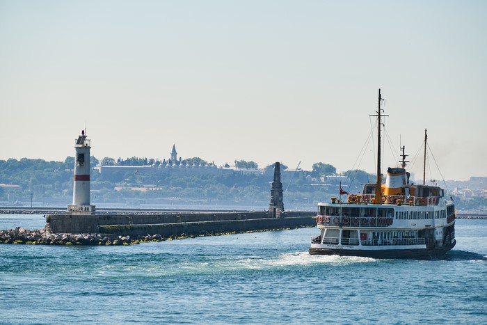 Ferryboat passing a lighthouse in Istanbul, Turkey