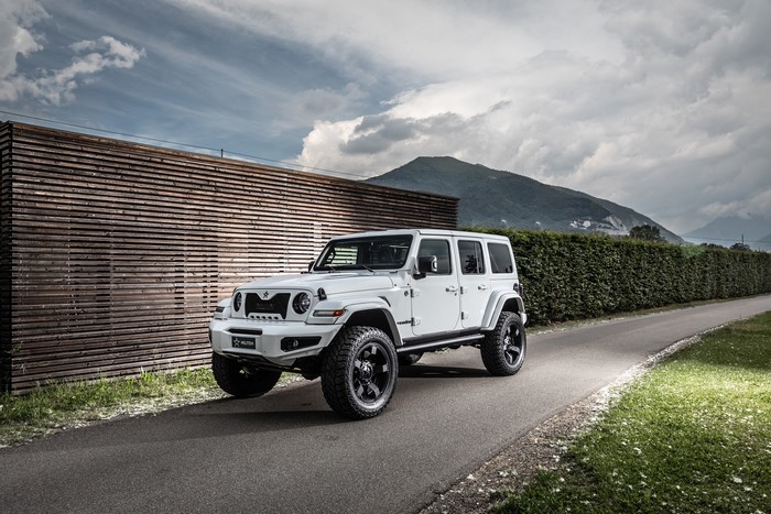 White Jeep Wrangler on a Road with Mountains