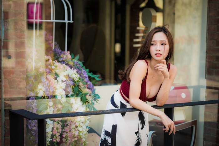 4K Asian Woman Posing on Balcony with Floral Bokeh