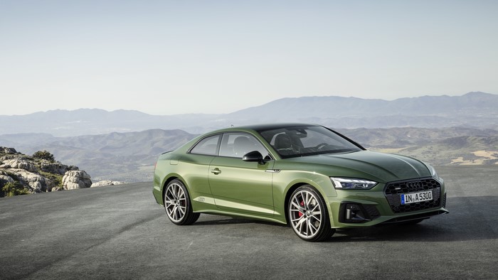 Green Audi A5 Coupe S line on a mountain road