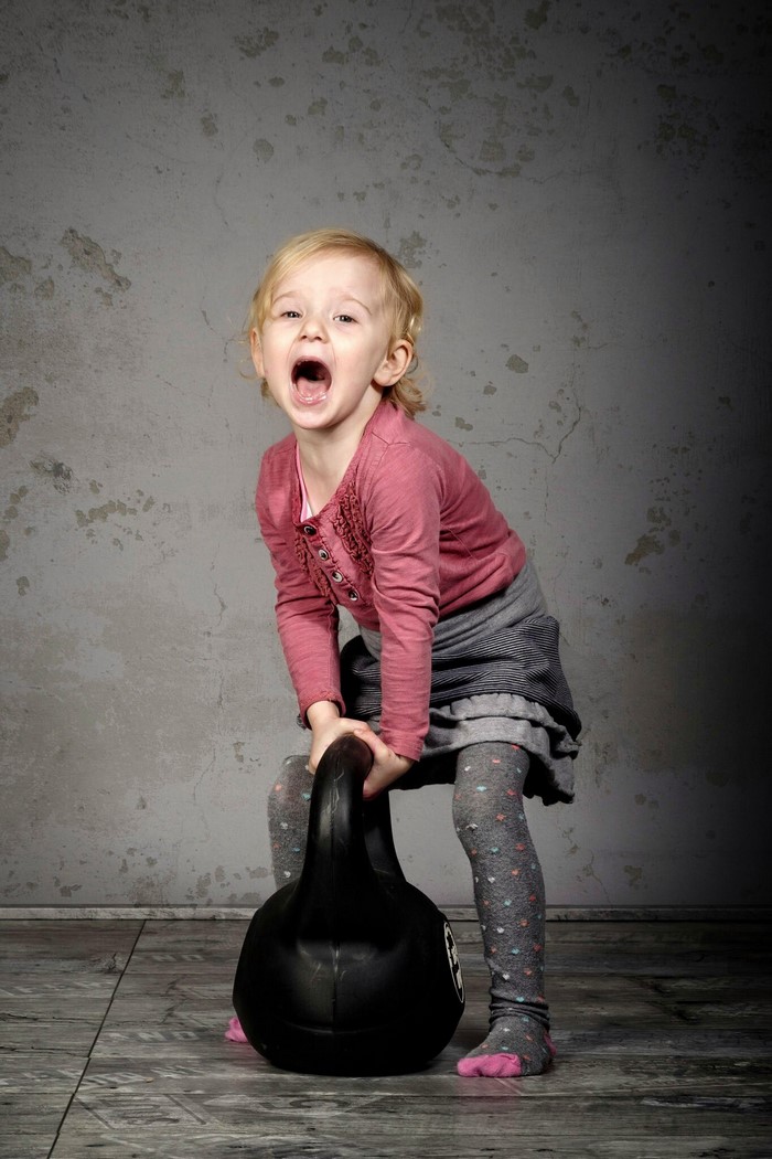 Girl lifting a kettlebell