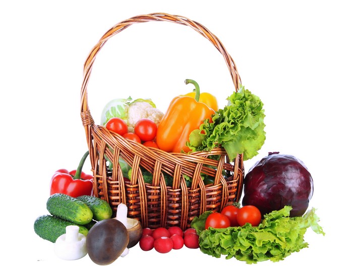 Vegetables in a wicker basket with white background
