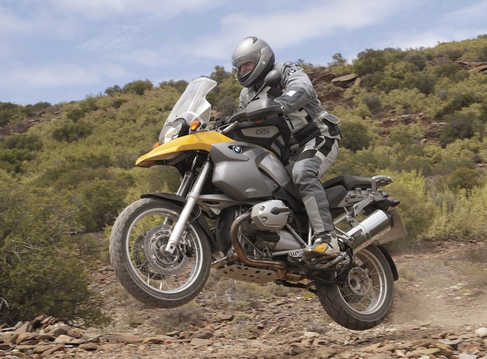 BMW R 1200 GS motorcycle jumping on a dirt road