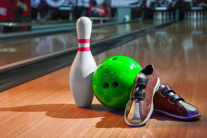Bowling pin, ball, and shoes on lane
