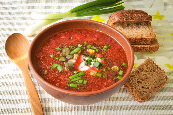 Bowl of Borscht soup with bread and spoon
