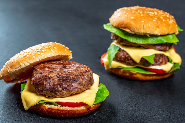 Two hamburgers with cheese and lettuce