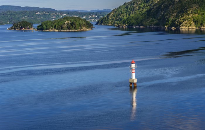 Lighthouse in a Norwegian Fjord with Islands