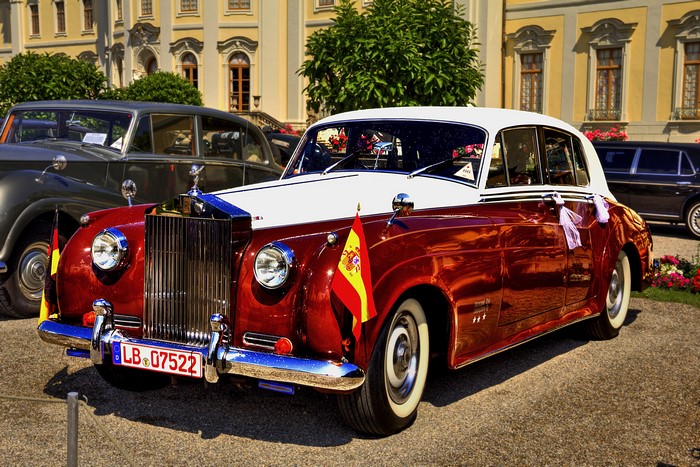 Red and white Rolls-Royce with Spanish flags