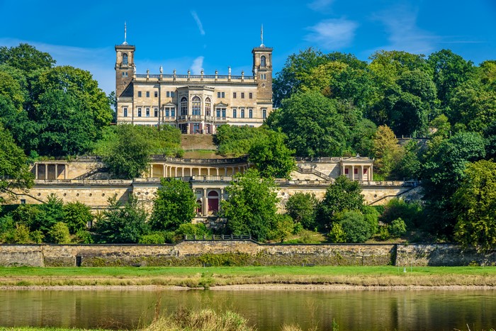 Albrechtsberg Castle in Germany with trees and river