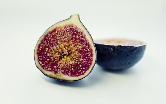 Common fig cut in half on gray background