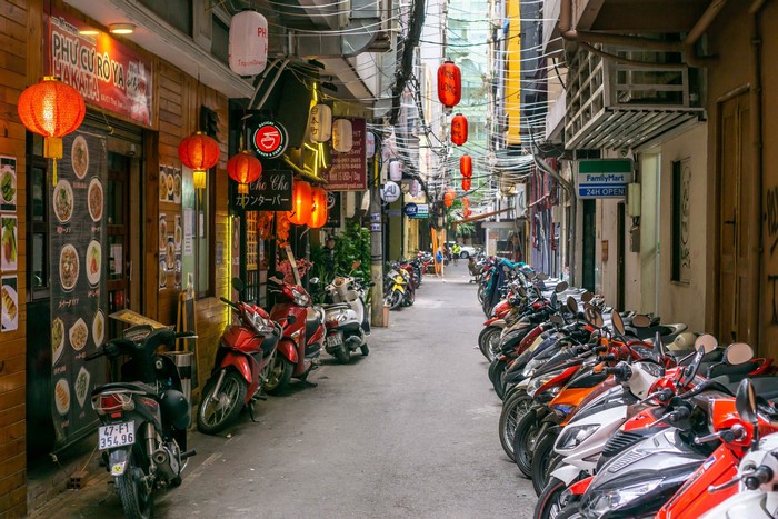 Street with motorbikes and shops in Saigon, Vietnam