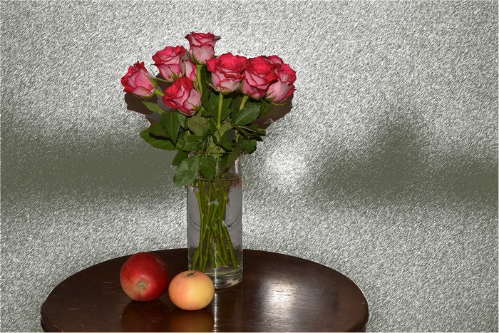 Bouquet of red roses with apples in a vase
