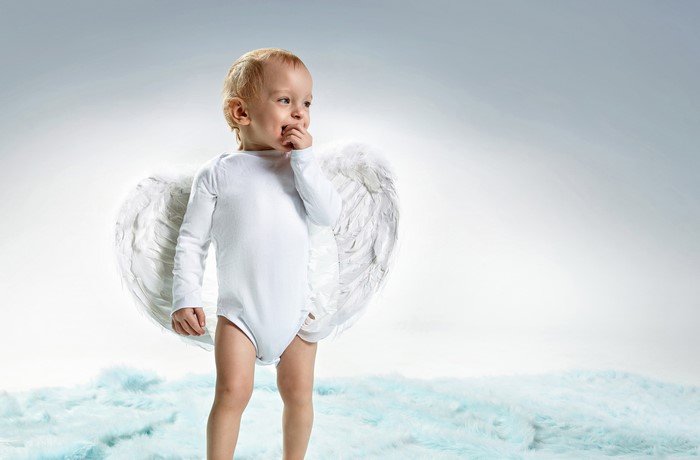 Baby boy with angel wings on blue fluffy ground