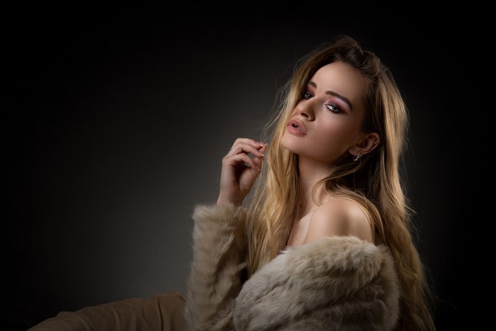 Woman with blonde hair wearing a fur coat