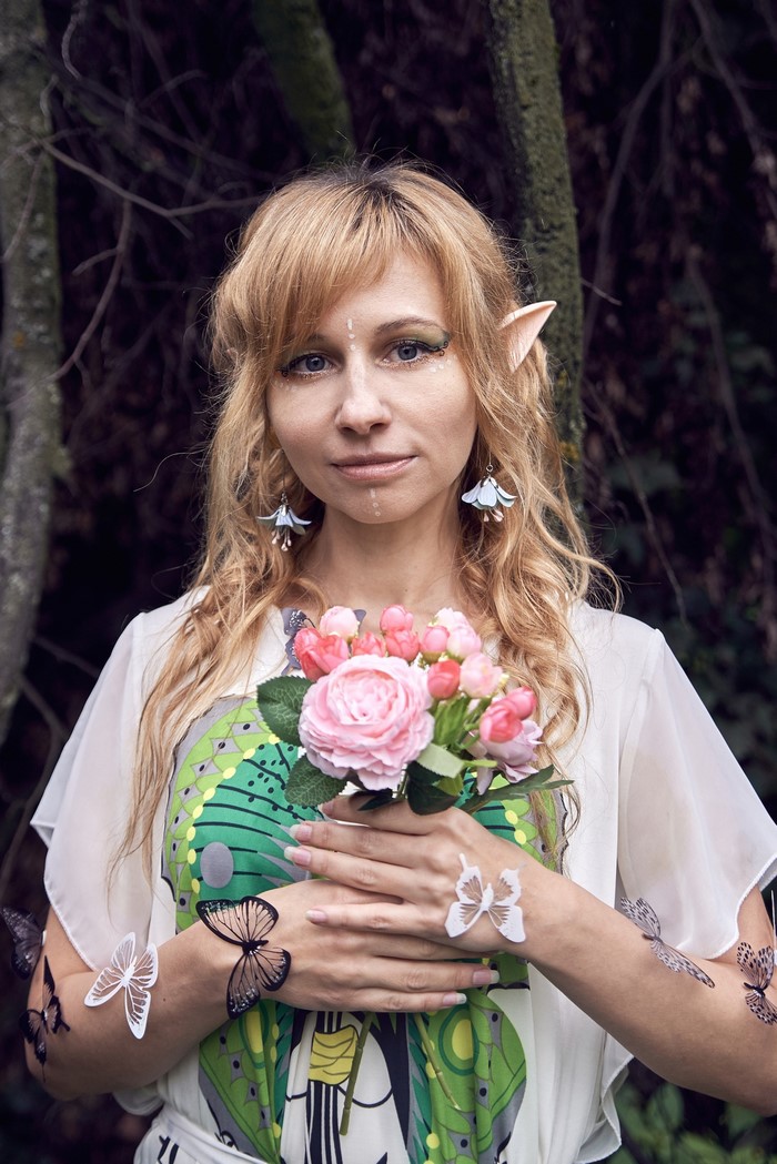 Blonde elf girl with flowers and butterflies