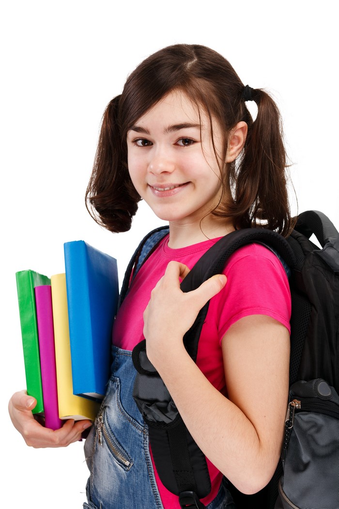 Girl with pigtails holding books and wearing a backpack