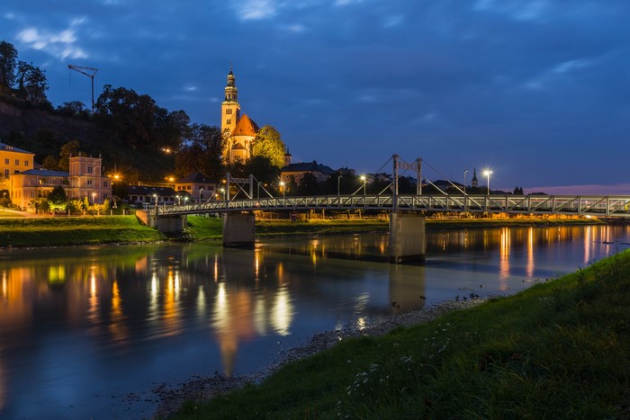 Salzburg, Austria at dusk with a bridge over the river