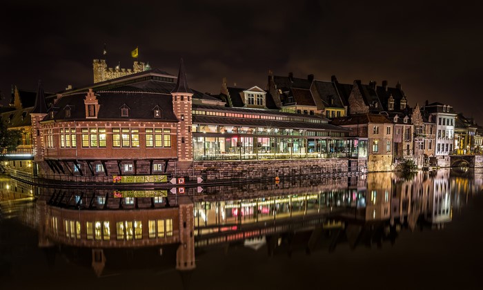 Ghent canal at night with historic buildings and reflections
