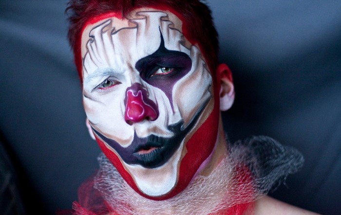 Man with clown makeup and red hair