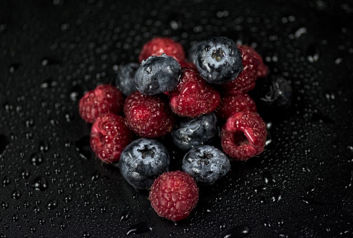 Raspberries and Blueberries with Water Drops