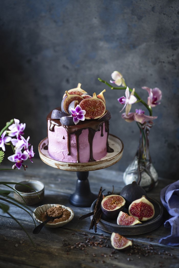 Pink cake with chocolate drizzle and figs
